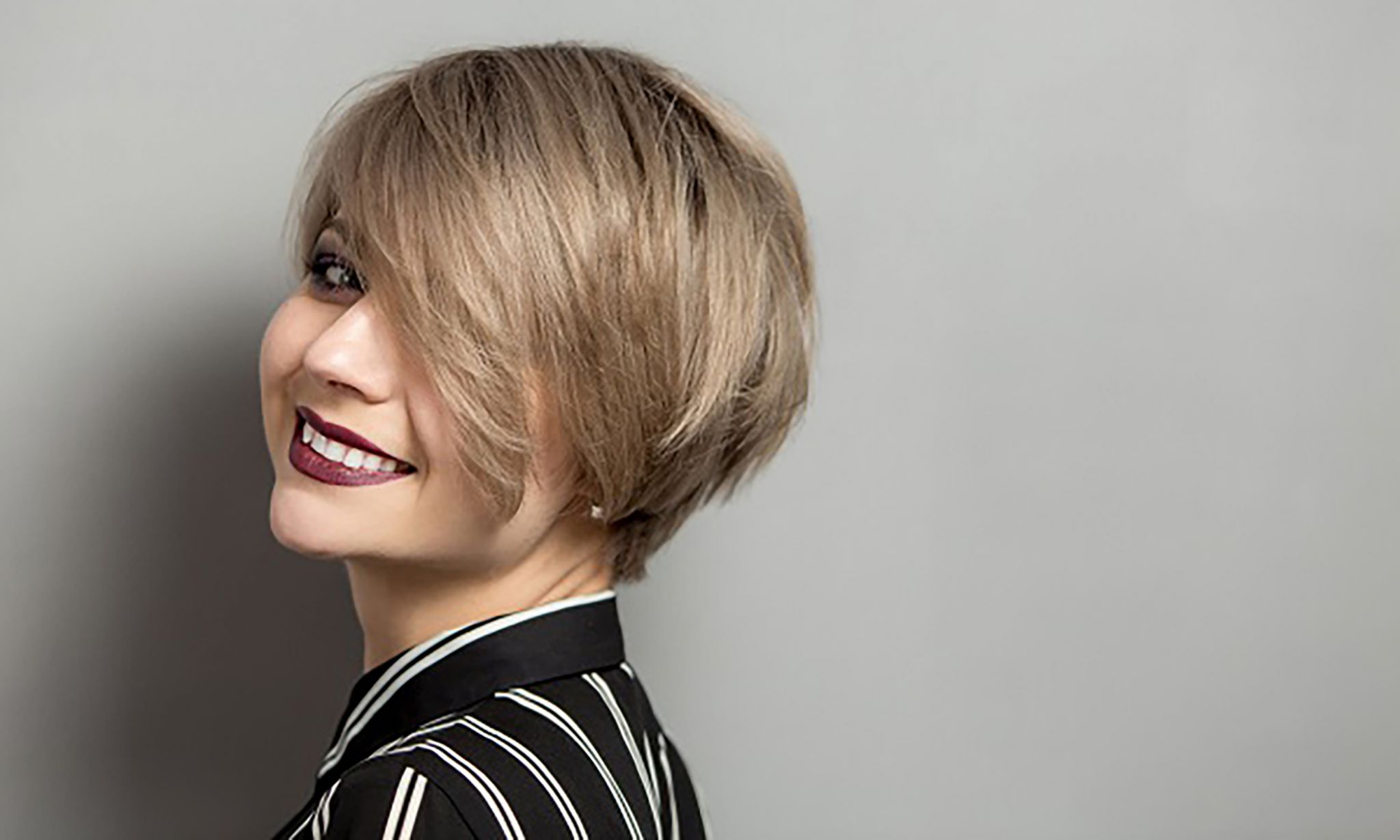 fashion beautiful young woman with short hair over gray background